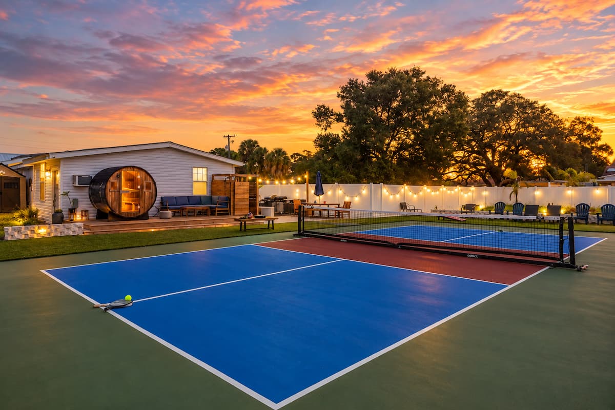 Barrel sauna and a private pickleball court at sunset at Flo Haus in Tampa, Florida