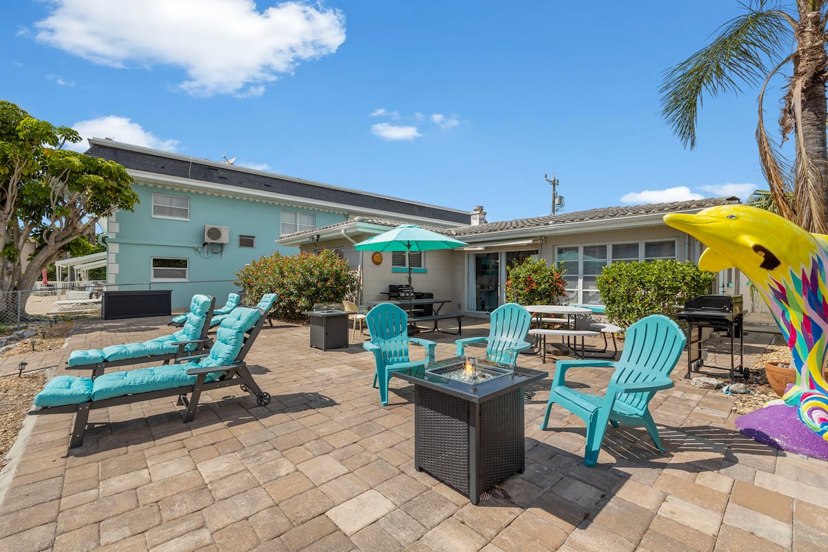 Sunny canal-front patio with loungers and fire pit on Treasure Island
